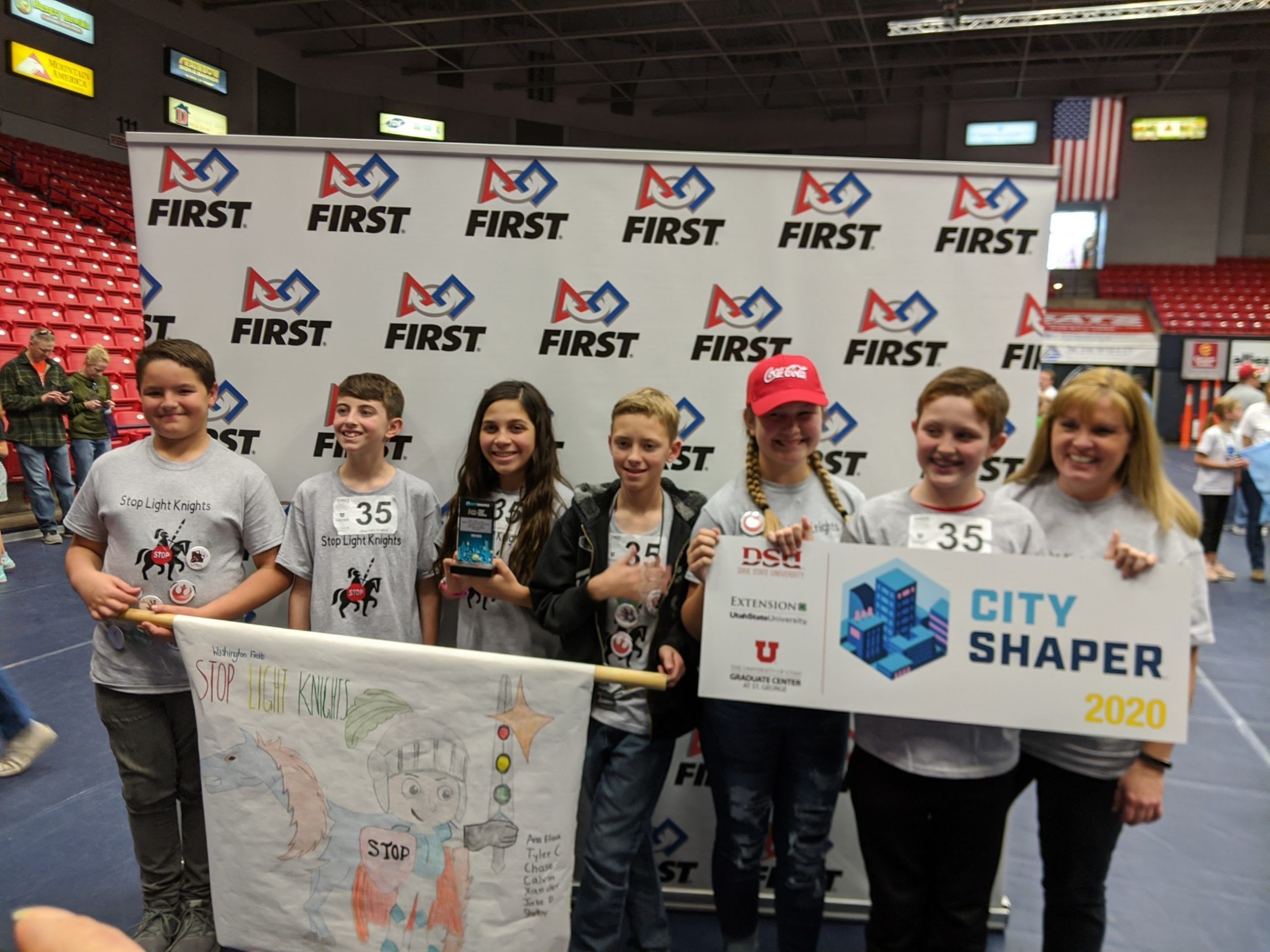 students hold banners for city shaper competition