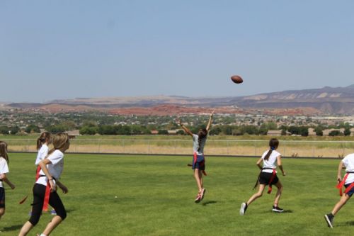 girl students playing flag football