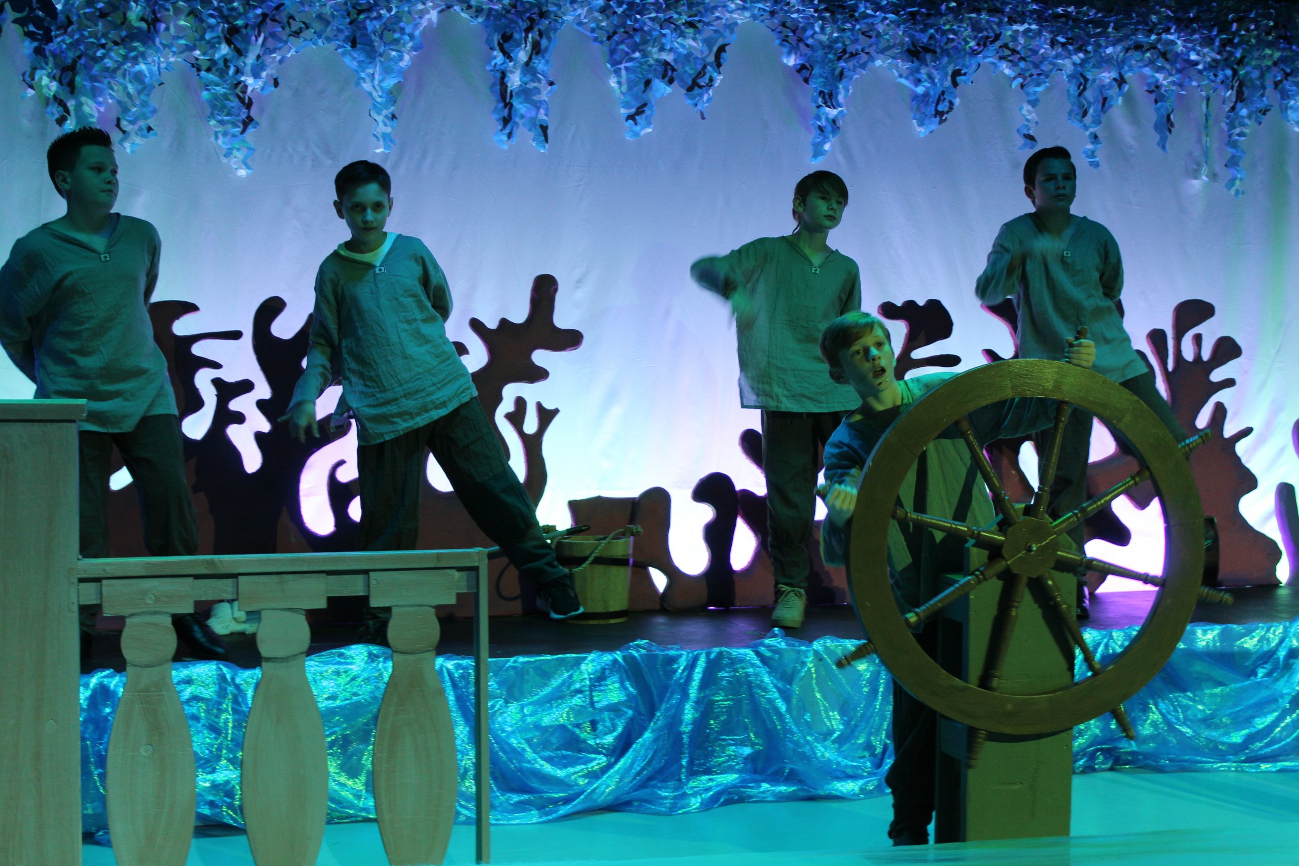 5 boys standing on deck of ship